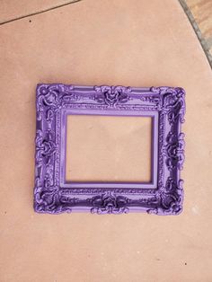 a purple frame sitting on top of a tile floor