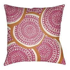 an orange and pink pillow with circular designs on the front, against a white background