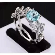 This Lovely Ring Showcases A Brilliantly Faceted Sea Blue Round .81 Carat Aquamarine. It's A Lab Created Gemstone That Reflects The Flawless Brilliance Of The Finest Genuine Gemstones - But At A Fraction Of The Cost. It's The Focal Point Of This Mesmerizing Ring Of Graceful Swirling Leaves Accented With Sparkling Swarovski Crystals. Ocean Wedding, Lovely Ring, Sea Blue, Ring Size 7, Blue Sea, Blue And Silver, Aquamarine, Floral Rings, Silver Ring