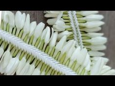 white flowers are arranged on a wooden surface