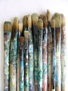 many brushes are lined up against the wall