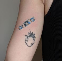 a woman with a tattoo on her arm and a skateboard behind her back shoulder