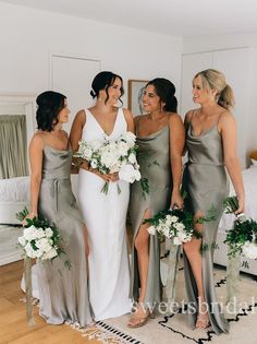 the bridesmaids are all dressed in gray dresses and bouquets for their wedding