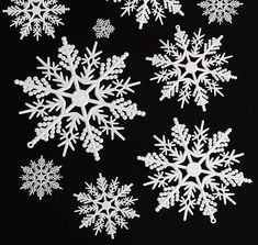 several snowflakes are shown on a black background