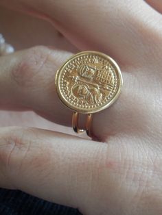 Vintage Signet Ring, Classic ring, Greek coin gold ring,Greek jewelry, Adjustable ring, gold coin ring, Greek Constantine ring, It is a modern and timeless ring that will never go out of style. Gold coin depicted Saint Constantine and Virgin Mary Size of coin is about 18mm Size ring is adjustable but for better fit I suggest it for size 50 - 60 or 5-9 US Ring made from double Gold plated 24K over sterling silver 925 If you don't know your ring size: you may stop at any jewelry store to have your Symbolic Gold Midi Rings With Open Ring Design, Gold Brass Engraved Ring, Symbolic Gold Midi Rings With Open Shape, Symbolic Gold Open Midi Ring, Vintage Coin Shaped Signet Ring Gift, Vintage Coin Signet Ring As Gift, Vintage Coin Signet Ring For Gift, Gold Coin Shaped Signet Ring, Gold Coin-shaped Signet Ring For Gift