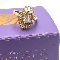 Elizabeth Taylor For Avon Evening Star Ring Size 8 Large Cz Ring Is Designed To Look Like Real Diamonds 7/8" X 5/8" Raised Setting Of Rounds And Baguettes Oval Center Original Box Included Excellent Condition Elizabeth Taylor Ruby Ring, Elizabeth Taylor Jewelry Rings, Vintage Avon Rings, Elizabeth Taylor White Diamonds Perfume, Avon Rings, Rare Gold Avon, Evening Star, Avon Jewelry, Cz Ring