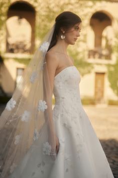 a woman wearing a wedding dress and veil