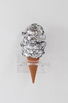 an ice cream cone with silver foil on top