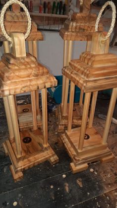 two wooden lanterns sitting on top of a floor next to each other in a room