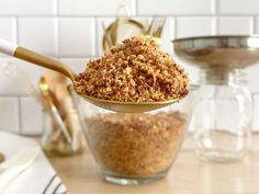 a spoon full of granola sitting on top of a counter