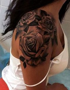 a woman with a black rose tattoo on her shoulder