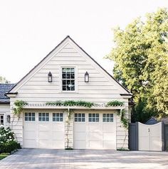 a large white house with two garages