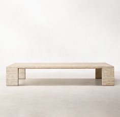 a wooden bench sitting on top of a white floor