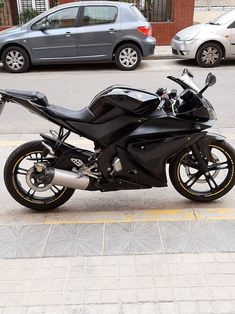 a black motorcycle parked on the side of the road