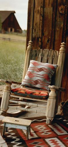 a wooden rocking chair sitting on top of a rug