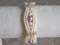 the bracelet is adorned with multi - colored pearls