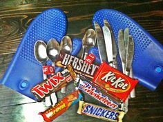 spoons, forks, and candy on a table with blue plastic utensils