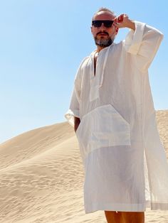 Hand made From start to finish Linen and cotton mixed lightweight fabric night gown for men Mens natural fabric caftan It's a special kind of linen which is only made in Anatolia ( i uploaded the fabric's detailed picture ) Lightweight White color Plus size avalible Small/medium/large/ xlarge / 2XL / 3XL / 4XL / 5XL size options Feel free to Ask for custom made Front pocket - kangaroo pocket Gift for him Super comfortable men's clothing to wear at home or outdoor Linen outfit Nightgown Pool part Casual White Long Sleeve Thobe, Elegant Summer Tunic Thobe, Traditional Linen Kaftan For Summer, Casual Long Thobe For The Beach, Casual Tunic Thobe For The Beach, Casual Summer Vacation Thobe, Casual Long Thobe For Vacation, Casual White Long Sleeve Kaftan, White Long Thobe For Summer