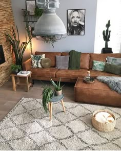 a living room filled with lots of furniture next to a fire place and potted plants