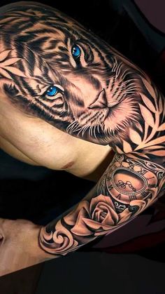 a man's arm with a tiger tattoo on it, and an intricate design