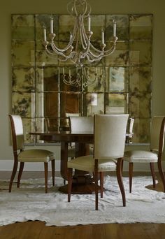 a dining room table with chairs and a chandelier