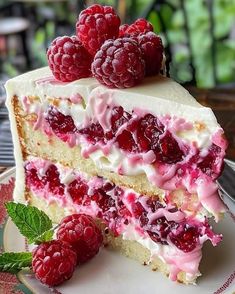 a piece of cake with raspberries on top