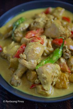 a bowl filled with chicken and vegetables on top of a table