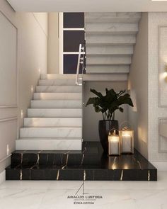 a white staircase with black marble steps leading up to it