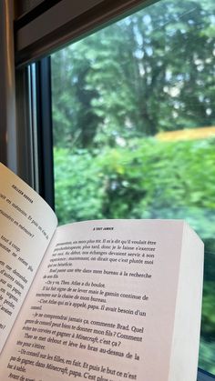 an open book sitting on top of a window sill