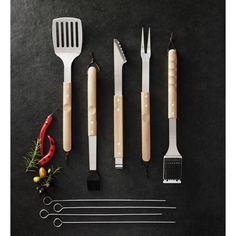 kitchen utensils are arranged on a black surface