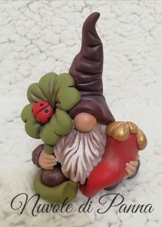 a gnome figurine sitting on top of a white surface