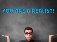 a man sitting in front of a blackboard with the words you are a realist on it