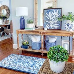 a living room filled with furniture and plants on top of a wooden table in front of a mirror