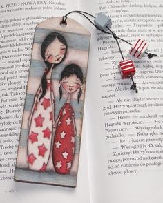 a bookmark with two girls on it and an american flag tag attached to it