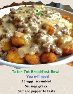 a bowl filled with tater tots covered in gravy on top of a table