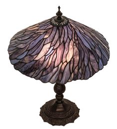 a lamp that is sitting on top of a wooden stand with a purple glass shade