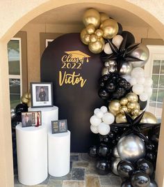 balloons and decorations are displayed in front of a graduation sign