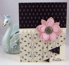 a close up of a card with a bird and flower on it