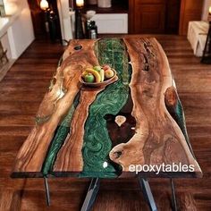 a table made out of wood and metal legs with fruit in bowl sitting on it