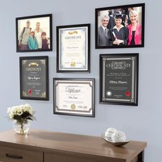 a desk with some framed pictures on the wall