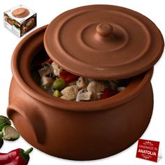 a clay pot filled with food next to a box of marzillo peppers and other ingredients