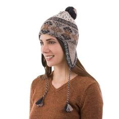 Elegant motifs in tan eggshell graphite and burnt orange reflect the diverse nature of Andean life. Peru's Fernando Cano presents a warm soft chullo hat knit from 100% alpaca wool and finished with tassels on the ear covers and a fuzzy pompom on the top. Alpaca Beanie For Outdoor, Outdoor Alpaca Beanie Hat, Adjustable Alpaca Hat For Outdoor, Alpaca Hat For Outdoor Winter Use, Winter Outdoor Alpaca Hat, Adjustable Alpaca Winter Hat, Warm Nordic Hats For Outdoor, Nordic Style Warm Outdoor Hats, Adjustable Alpaca Beanie Hat