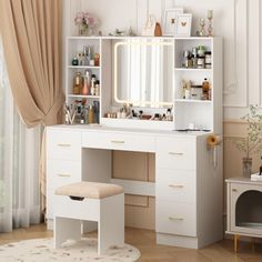 a white dressing table with a mirror and stool