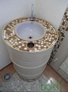 a white sink sitting in the corner of a bathroom