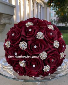 a large bouquet of red roses on a glass platter