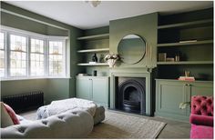 a living room filled with furniture and a fire place next to a wall mounted mirror