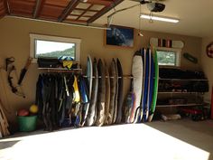 there are many surfboards in this garage