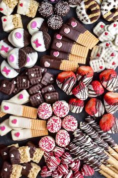 an assortment of heart shaped cookies and desserts