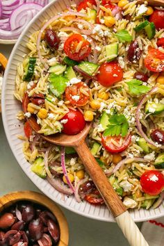 a salad with tomatoes, cucumbers, onions and other vegetables in a bowl