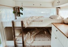 there is a bunk bed in the middle of this room with white walls and wood flooring